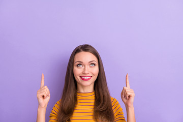 Close-up portrait of her she nice attractive pretty cute cheerful cheery glad girl pointing two forefingers up ad copy space isolated over violet purple lilac pastel color background