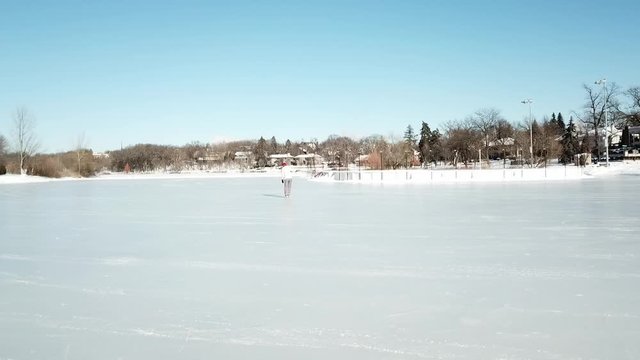 Girl learning ice skating during a winter sunny afternoon in Minnesota