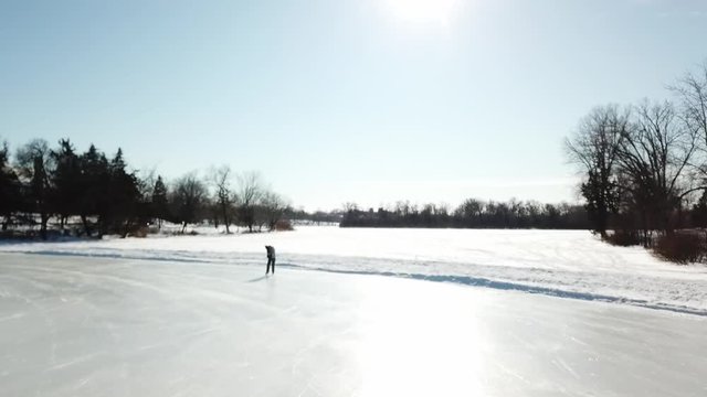 Frozen lake with somebody standing, sunny afternoon