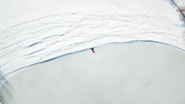 Aerial view, perspective, guy layed in ice and snow, birds eye view