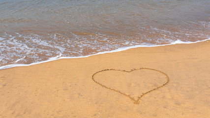 14 February. Valentine's Day. Heart drawn in the sand. Day of lovers. Congratulations. Sandy tropical beach with painted hearts. 