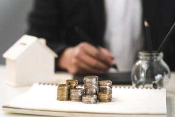 Silver and gold coins stacked on the work desk,Money for business, growth and investment