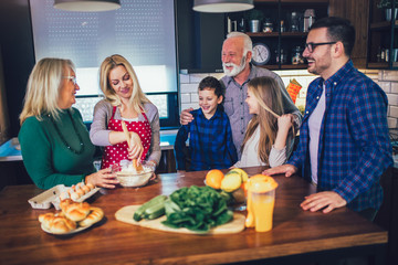 Happy family cooking together at home and smiling