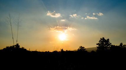 Sunset evening with beautiful colour of sun ray spread over. clouds are small but perfect in crown shape. Background sunset.