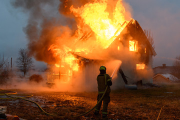 Norwegian firefighter trying to put out flames house on fire