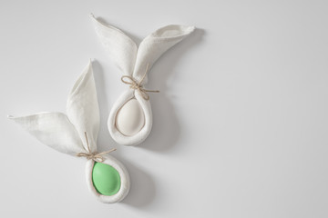 Easter table decoration with napkin in the form of rabbit ears and eggs. Festive easter minimalism.