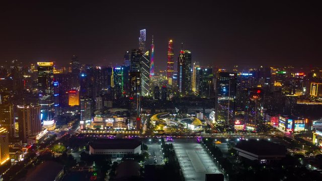 flight over guangzhou city night illumination famous downtown traffic street square aerial timelapse panorama 4k china