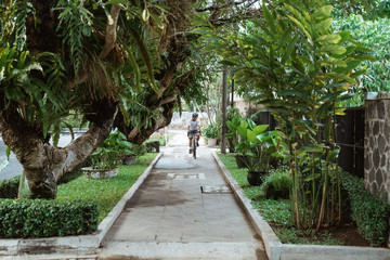 young man wearing bike helmets when riding bicycle in the park in the morning
