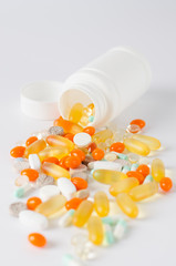 Assorted colorful tablets, pills, drugs on white background. Medication and healthcare concept.