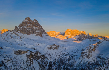 An incredible sunset in the Dolomites Alps in the Tre Cime di Lavaredo national park in january 2020 in Italy. Aerial drone shot