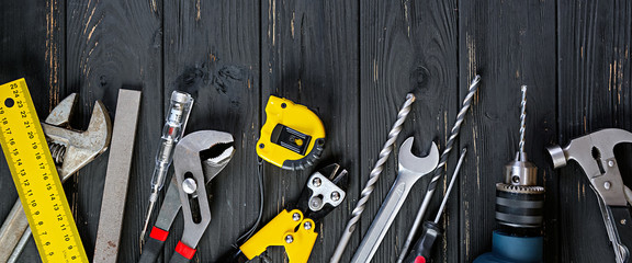 Set of working tools on wooden rustic background. Top view. Copy space