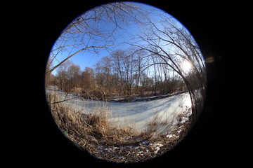 Naklejka premium Frozen river in forest. Circular fisheye landscape