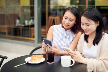 Two female friends meeting at a coffee shop