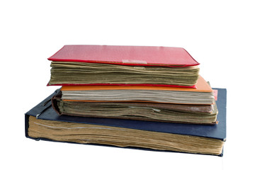 A stack of old photo albums isolated on a white background