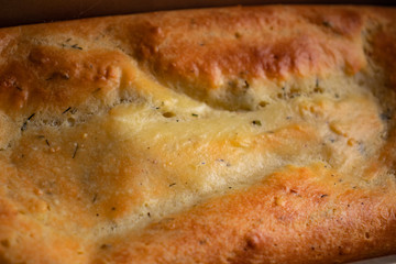 Close-up of fresh rosy ricotta cheese bread with greens and crispy crust