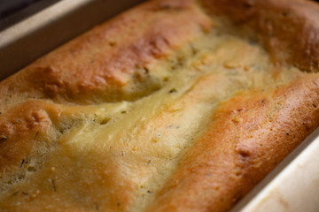 Close-up of fresh rosy ricotta cheese bread with greens and crispy crust