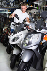 Fototapeta na wymiar Customer man is choosing new motorcycle