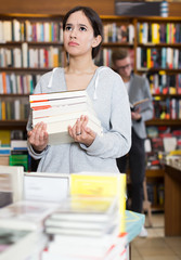Portrait of active girl with stack of books