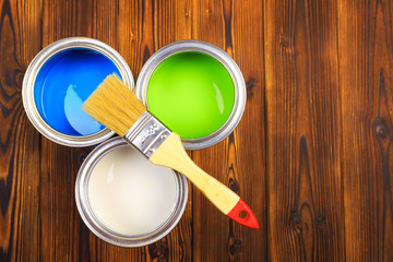 House renovation, paint cans on the old wooden background with copy space - Image