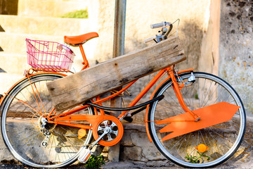 orange ride bike with wooden sign