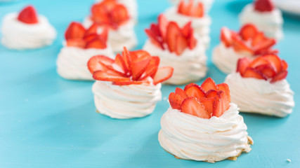 pavlova meringue nests with strawberry cream and fresh strawberries