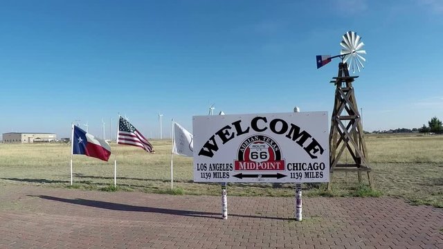 Route 66 Mid Point marker, abandoned bridges and Route 66 sign on street of historic Route 66. Includes four different video sequences!