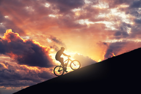 Riding Mountain Bike On A Ramp Against Cloudy Sky. Achieving The Difficulty And Improvement Concept.