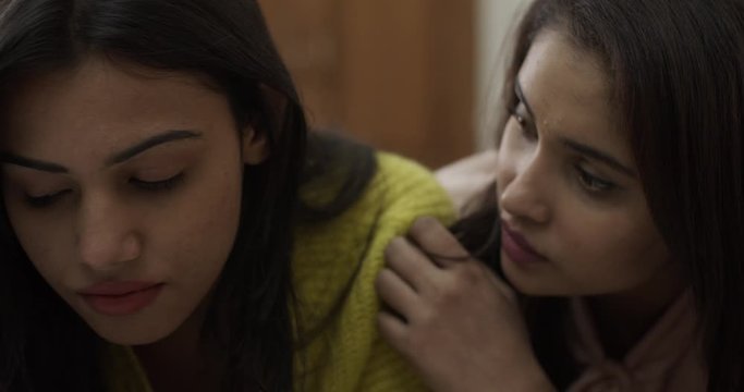 Young Indian women in bed as they try to talk with each other and listen to deepest fears to make other relaxed as in a good friend and also interested romantically in love- slow-motion 60fps handheld