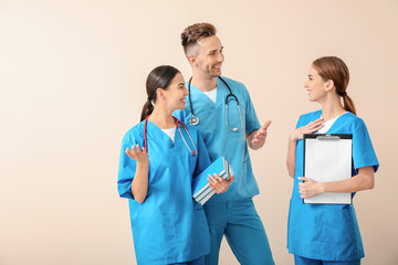 Group of medical students on light background