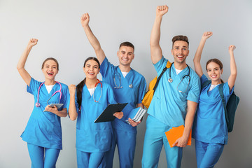 Group of happy medical students on light background
