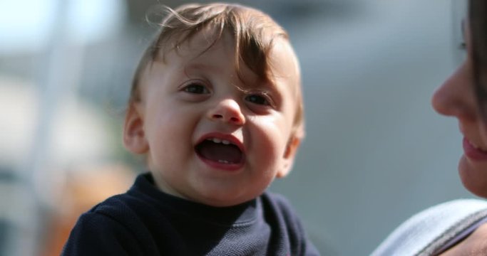 Cute bashful baby hiding face with hands