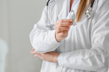 Female doctor with Parkinson's awareness ribbon in clinic