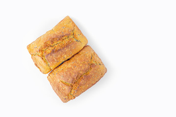 Two loaves of whole-grain bread on white background. Freshly baked homemade square bread. Organic and vegetarian food concept. Copy space for text, flat lay