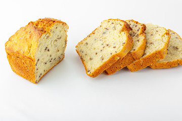 Sliced loaf of whole-grain bread on white background. Freshly baked homemade square bread. Organic and vegetarian food concept. Copy space for text, close up
