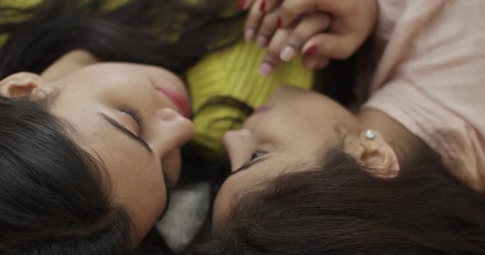 Lovers lying together close up intimate and embracing each other as they dream of being together forever on Valentine's day date being spend on the bed, holding onto the love of their life slow-motion