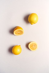 Overhead View Of Whole And Halved Fresh Lemons On White Background