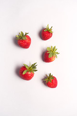 Overhead View Of Individual Fresh Strawberries On White Background