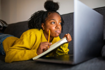 Close up african girl student looking at laptop computer screen