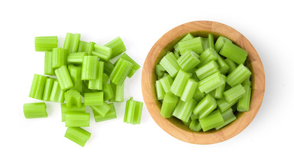 celery in wood bowl isolated on white background