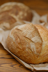 Assortment of baked bread on wooden table background. Bread background, top view of white, black and rye loaves. Healthy food. 