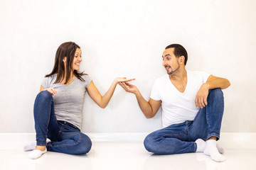 Smiling young couple holding palm open with copy space for text or product isolated on white background.