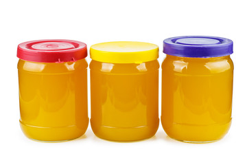 Glass jars with honey isolated on white background