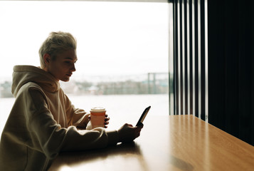 Young woman on the phone in cafe