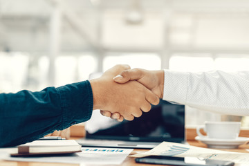 Business shaking hands, finishing up meeting. Successful businessmen handshaking after good deal.