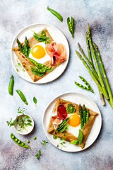 Buckwheat crepes, galette bretonne with asparagus, egg, green pea, jambon or prosciutto. Galette sarrasin, french brittany cuisine