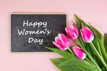 Pink tulip flower on blue wood table background with copy space for text. Love, International Women day, Mother day and Happy Valentine day concept