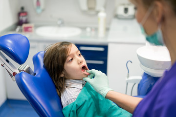 Young Smiling Boy Posing Before Regular Dental Check Up in Clinic