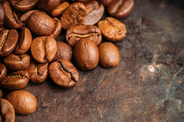 Coffee beans on the rustic wooden background. Selective focus. Shallow depth of field.
