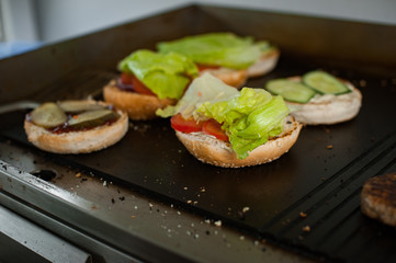 Grilling an vegetarian burgers on an outdoor grill.