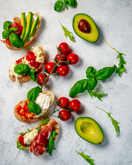 Different tasty bruschettas on light background, flat lay. Top view 